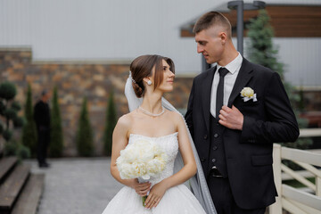 Couple shares a romantic moment outside during their wedding ceremony in a beautiful garden