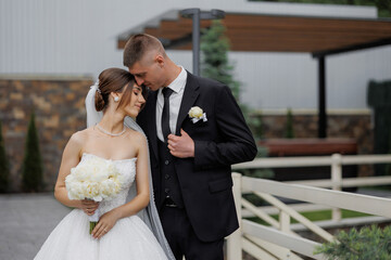 Couple enjoys intimate moment at outdoor wedding venue during sunny afternoon