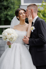 Newlywed couple celebrates love in a beautiful garden on their wedding day