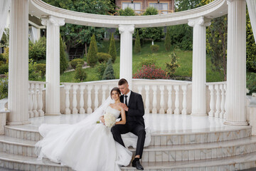 Couple enjoys a romantic moment at a wedding ceremony in a lush garden setting