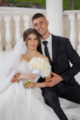 Couple celebrates their wedding day in beautiful venue with elegant attire and fresh flowers