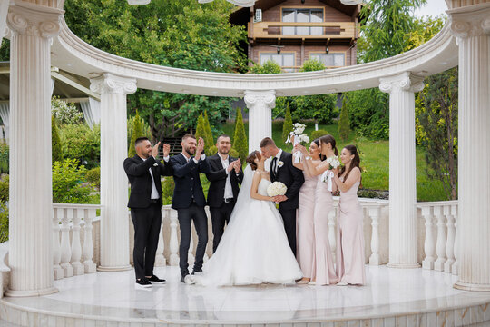Wedding celebration with joyful couple and party in elegant outdoor venue