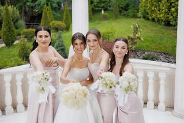 Bridal party celebrating wedding day at beautiful outdoor venue