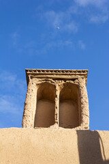 Historic windcatcher in Yazd, Iran, stands tall against a vivid blue sky—an iconic example of ancient Persian architecture and sustainable design.