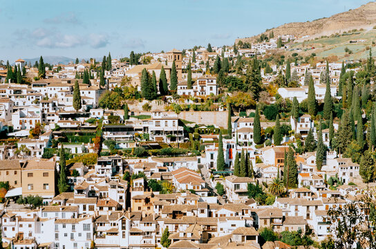 Golden hour postcard capturing Albaycin's layered structure from the Alhambra