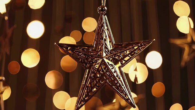 Golden star ornament gently swaying amidst warm festive lights
