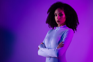 Stylish young woman in neon lighting wearing a trendy bodysuit, showcasing beauty, fashion