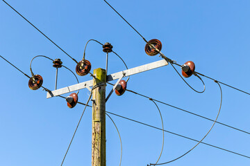 Electrical Insulators and Power Lines on a Wooden Pole