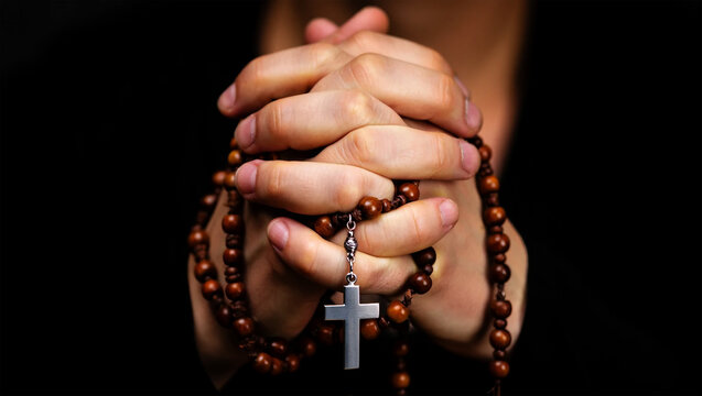 assumption day | Hands holding rosary beads with cross praying