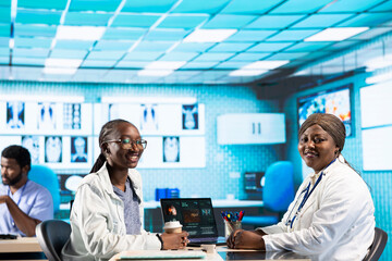 Portrait of african american medic expert having a conversation with young girl, gives her advice...
