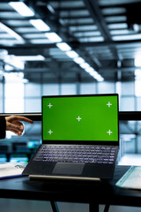 Technicians in data center using green screen mockup laptop, inspecting server clusters, updating...