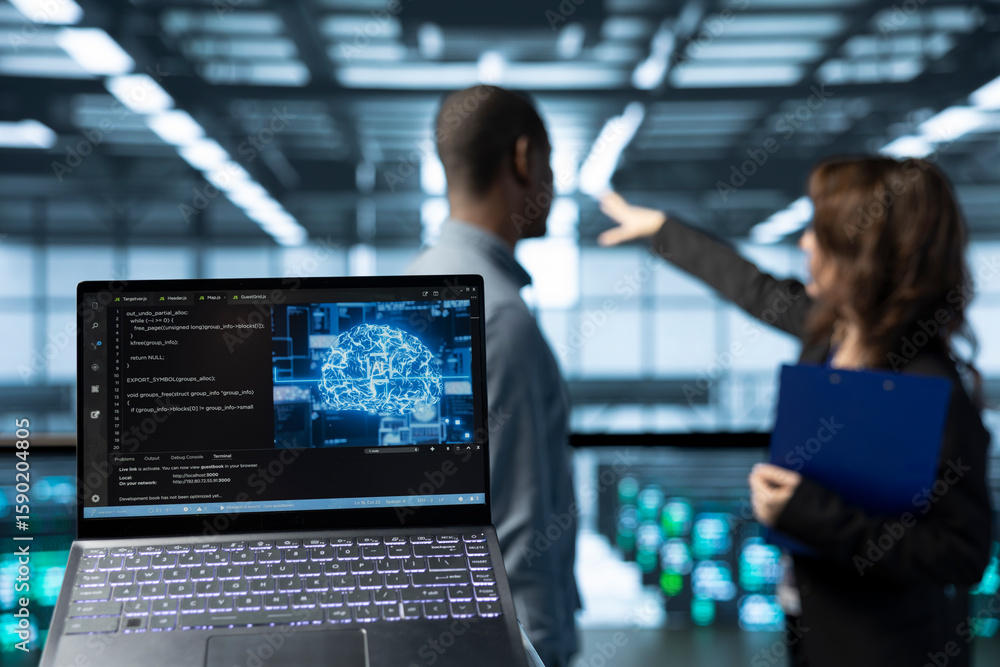 Poster laptop in front of data center technicians in blurry background deploying ai driven management tools