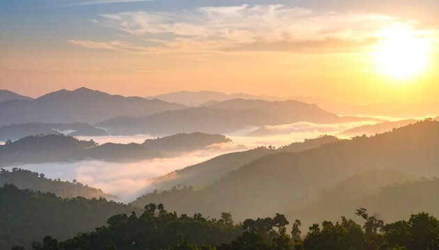 Sunrise over misty mountain ranges