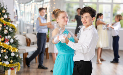 Couple boy and girl rehearsing waltz dance in studio