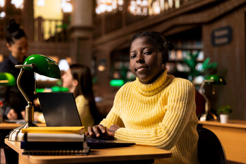 Preadolescent scholar working on a school assignment in the library, brainstorming ideas for a new...