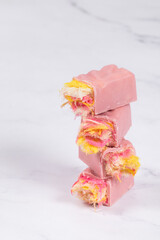 Vegan Modern pink candy. Angel Hair. Pink chocolate candy bar. With colored cotton candy. Light background. Close-up