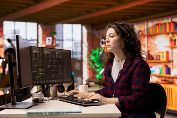 System administrator working in innovative startup office using programming languages to build...
