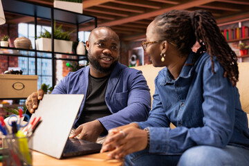 African American man asking his partner to take a break from remote work, sharing a supportive...