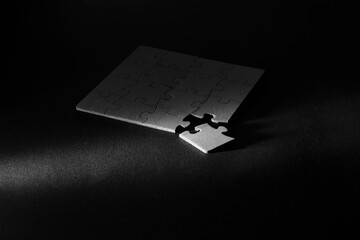 Business concept,collaboration,cooperation,teamwork, innovation,human resources,recruitment,team building, jigsaw puzzle pieces, black and white image. Shallow depth of field.