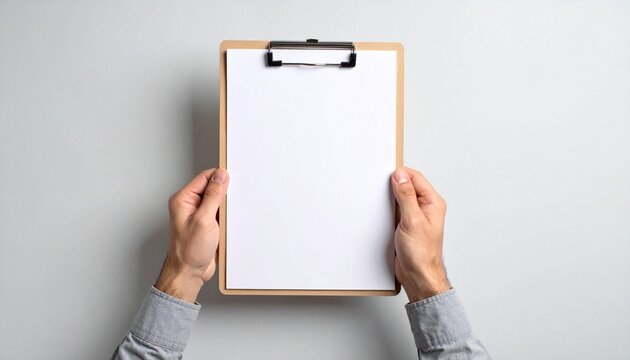 A person holds a clipboard with a blank sheet of paper, ready for notes or data