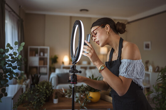 woman gardener prepare and set up equipment for record video at home