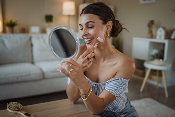 woman use facial massage tool at home and enjoy at time for herself