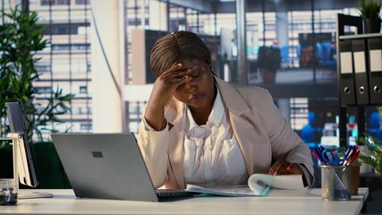 Overwhelmed nervous CEO having a migraine and working under pressure, feeling overburdened and...