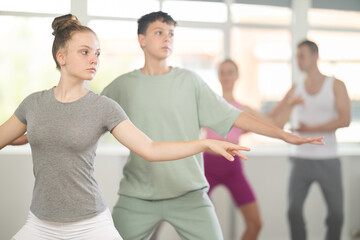 Ballet training for teenagers in a ballet studio under the guidance of a choreographer