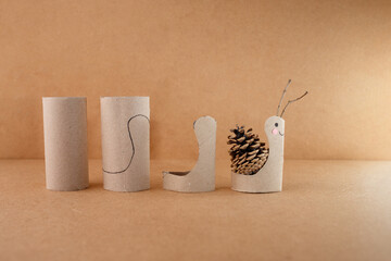 Whimsical snail figurines made from pinecones and twigs, perfect for kids education, eco-conscious...
