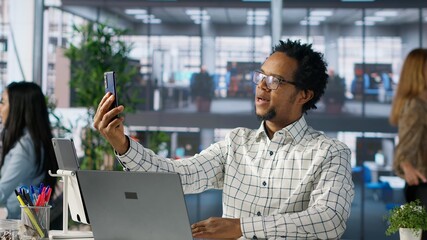 Professional man having a phone call conversation discussing business strategy and client goals....