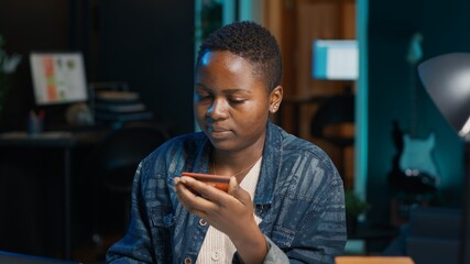 Woman doing internet shopping, carefully typing credit card information on laptop in apartment....