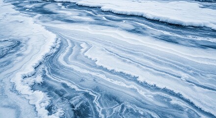Abstract aerial view of a frozen river or lake showing intricate patterns of ice, snow, and water.