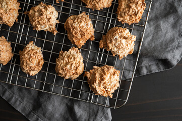 Baked Macaroons on a Wire Cooling Rack Close-up: Freshly baked coconut and meringue drop cookies cooling on a wire rack