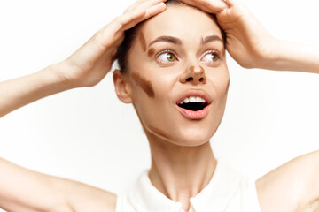 Young woman expressing surprise with hands on her head, showcasing beauty concept and makeup...