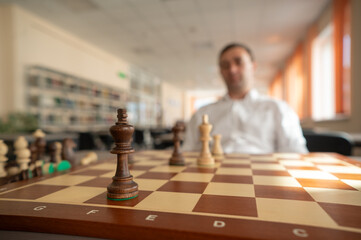 Middle aged Caucasian man playing chess. 