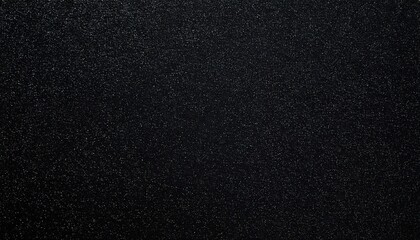 Dark, textured surface with fine specks