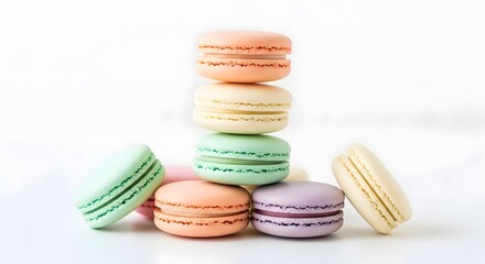 Obraz premium Colorful macarons stacked and scattered against a white background, photo