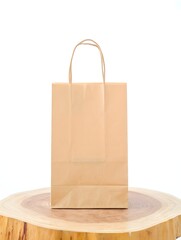Isolated brown paper bag mockup on wooden surface for shopping and branding design