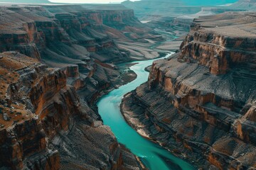 Aerial view of majestic grand canyon with turquoise river winding through rugged landscape