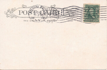 Old vintage postcard back with postage stamp