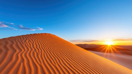 Majestic rise of the sun over the orange dunes of Merzouga in the Sahara
