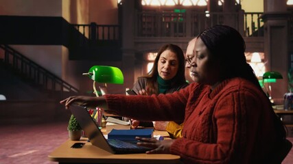 Focused students taking notes from academic library resources and reviewing archived materials in a study area, showing the dedication of mature education and knowledge building. Camera A. - Powered by Adobe