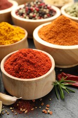Different aromatic spices on black table, closeup