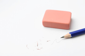 Pencil, eraser, doodle and scraps on white background, closeup. Space for text