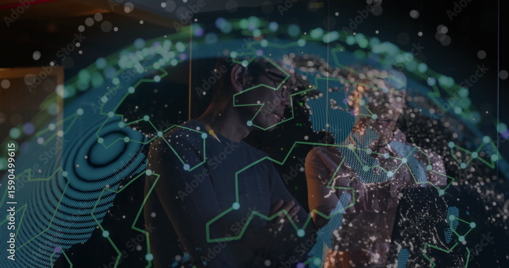 Poster examining network map, two tech professionals in business attire viewing holographic globe in lab
