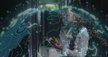 Using tablet IT professional navigating server rack corridor with holographic globe, copy space