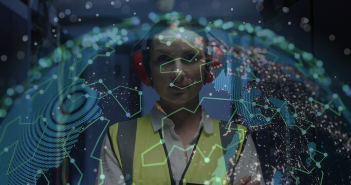 Monitoring network globe technician in data center corridor, wearing safety vest and red headphones
