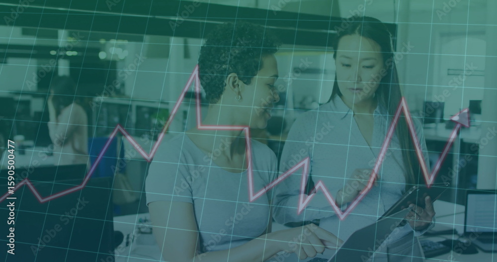 Poster reviewing tablet two colleagues in business attire analyzing data at office with line graph overlay