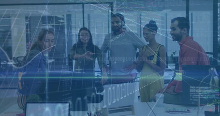 Collaborating professionals in business attire analyzing data in office, with monitors and laptop