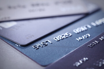 Many different credit cards on grey table, closeup